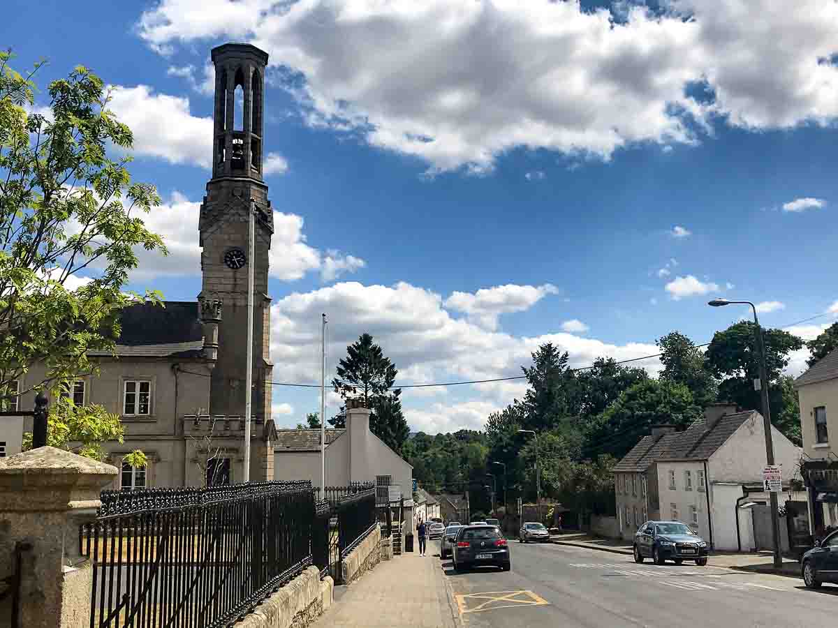 main street in borris carlow with church with tall bell tower and clock