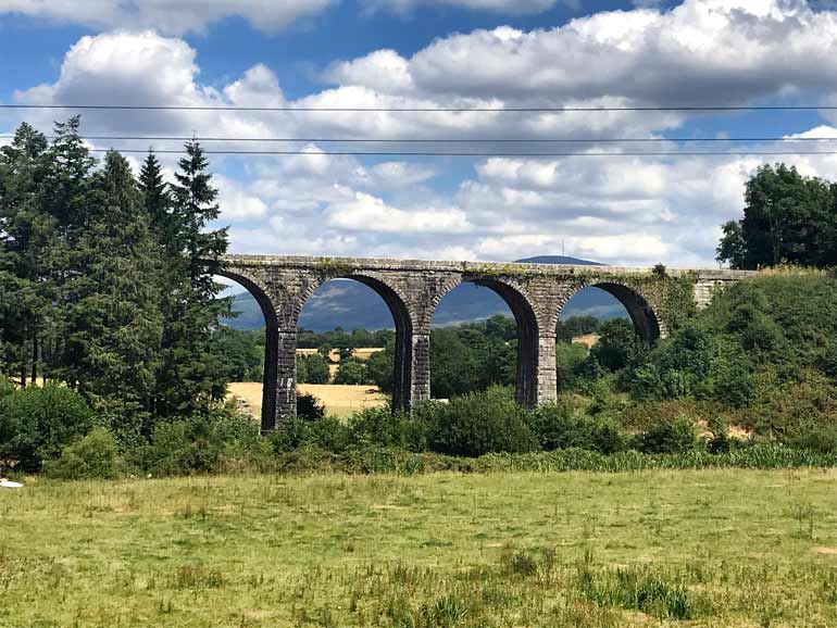 old stone viaduct in country fields