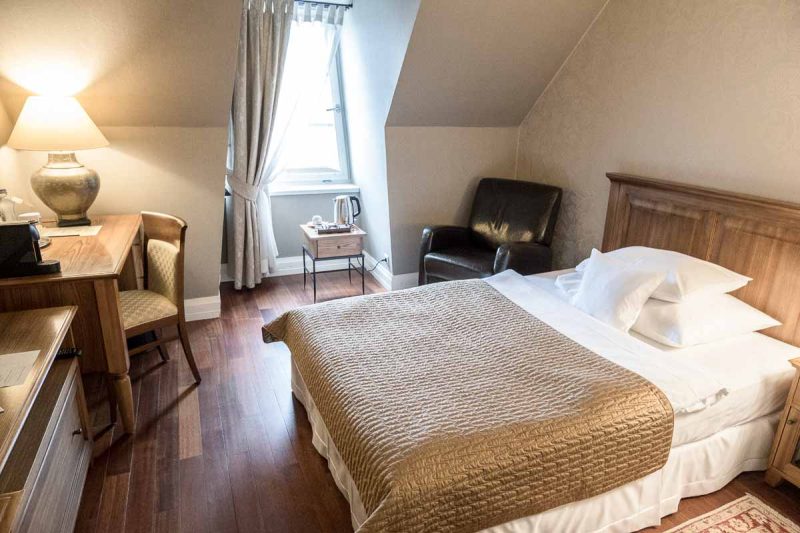 bedroom in marrols boutique hotel bratislava with double bed and table and chair