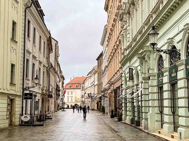 pretty street lined with pastel coloured buildings in bratislava slovakia