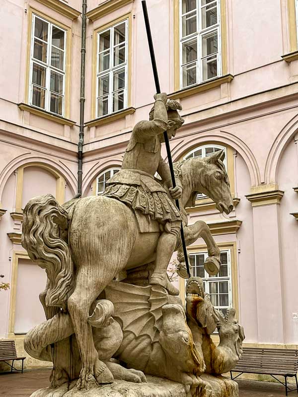 sculpture of st george on horseback fighting a dragon