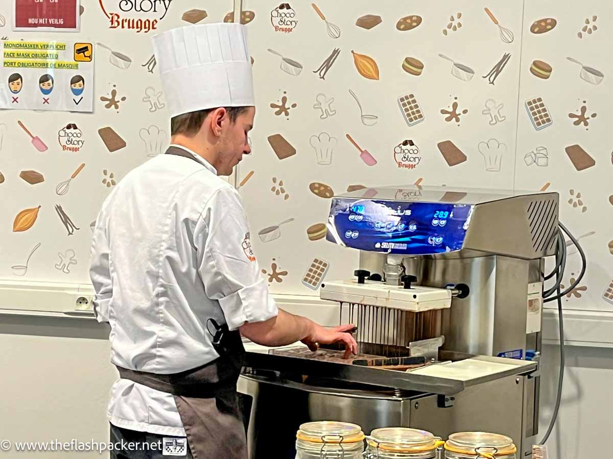 man dressed in white chefs hat making chocolate