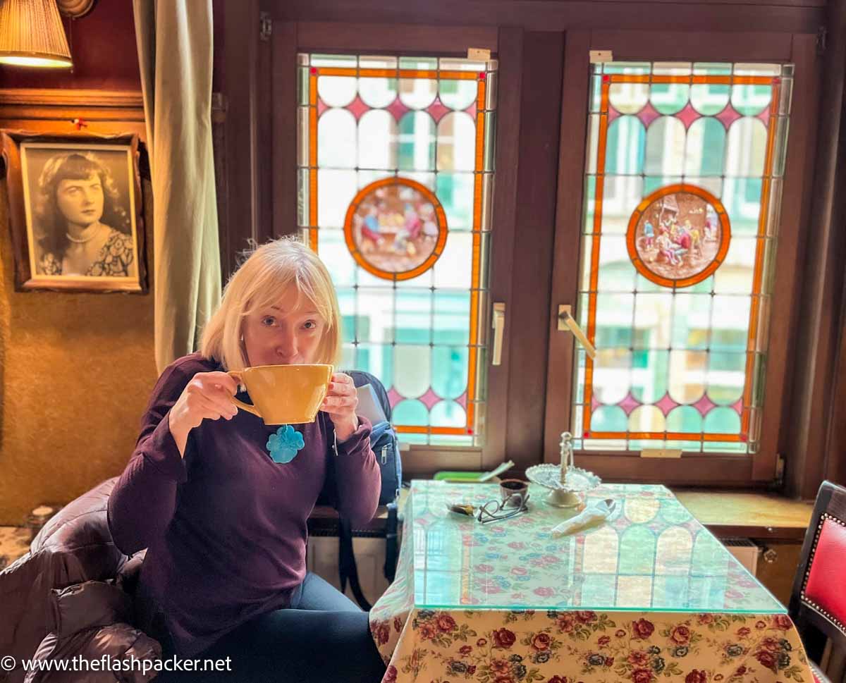 women drinking from a large mug in an old-fashioned tea room