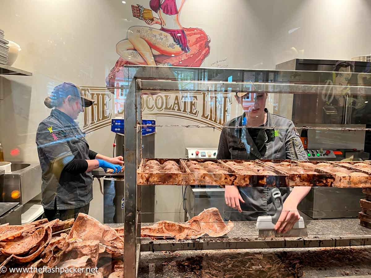 two women making chocolate in bruges belgium