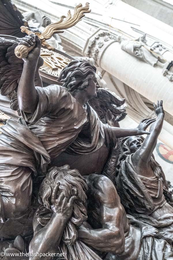 expressive carved wooden figures of church pulpit