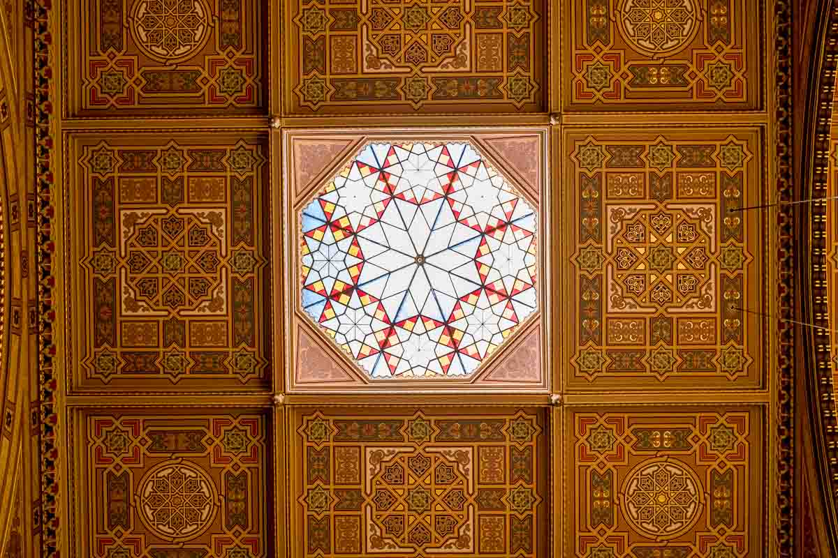 inlaid wood ceiling with geometric patterns and glass with 8 pointed stars