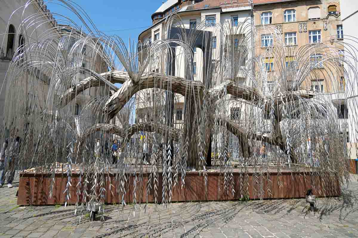 sculpture of a tree in a courtyard