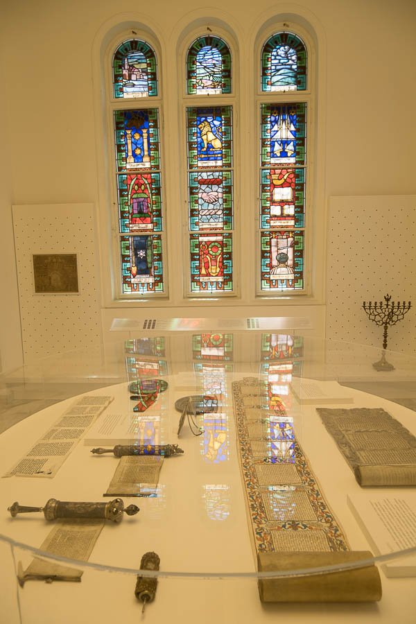 display case in hungaran jewish museum with torah scrolls