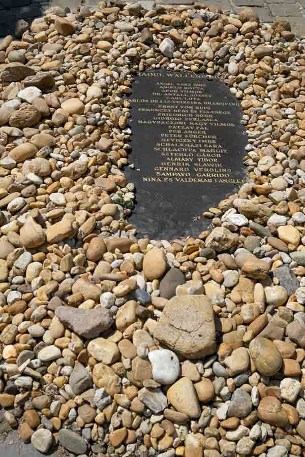 memorial plaque with list of names on a bed of stones