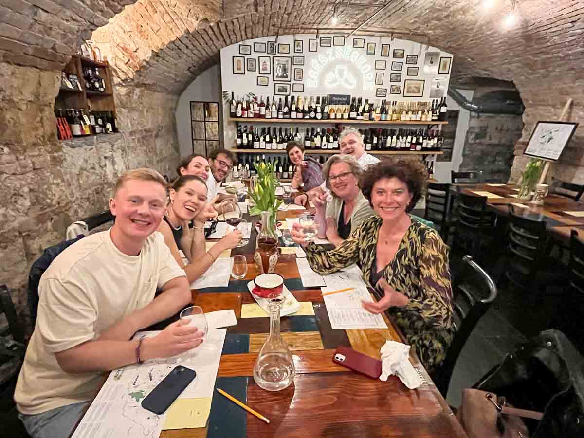 group of people sitting around a table during wine tasting