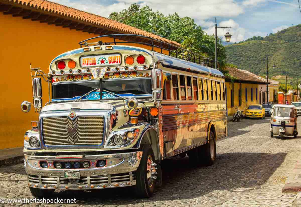 brightly coloured bus in a street in guatemala