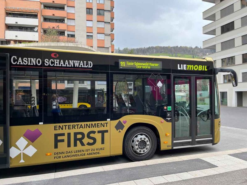 yellow and black bus that will take you on a day trip to liechtenstein from austria