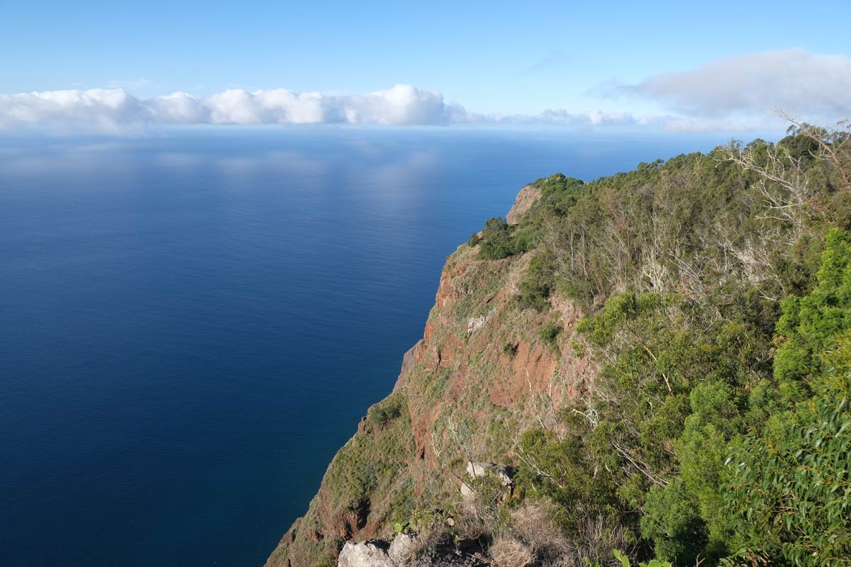 slope of cliff looking out to sea with clouds on horizon one of the things to see for solo travel in madeira