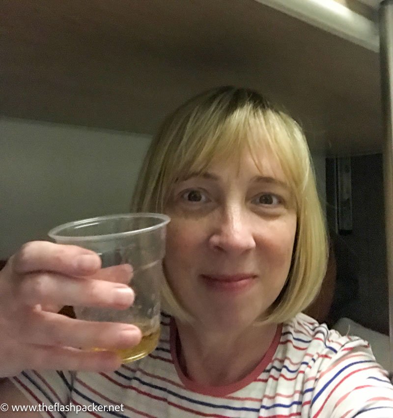 woman holding up glass of whisky