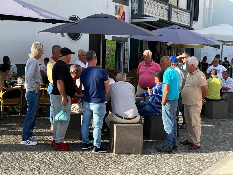 group of men playing card outside a cafe in camara de lobos madeira