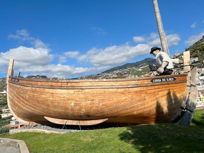 monument of a man in a wooden boat