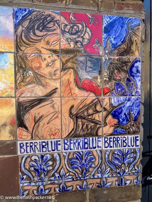 wall mural of slightly abstract woman and a bat with portuguese tiles