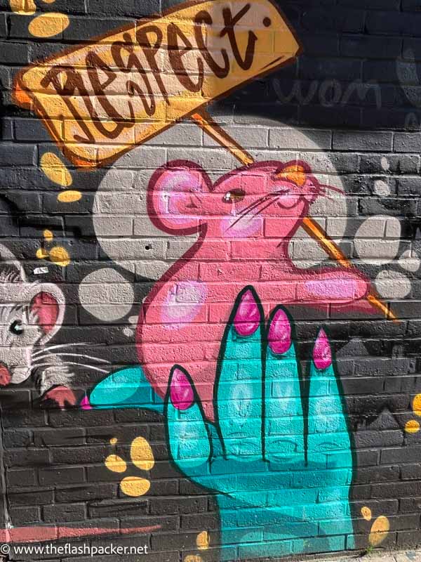 wall mural of a hand and mouse holding a sign saying respect