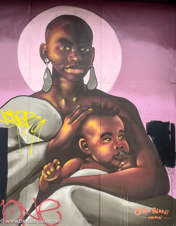 wall mural of an african woman holding a baby