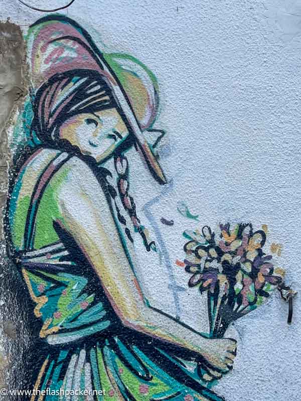 wall mural of a girl holding flowers