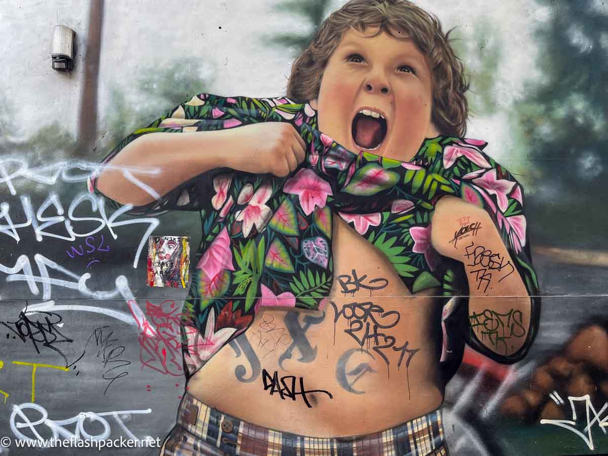 street artwork of chubby lad lifting up his shirt