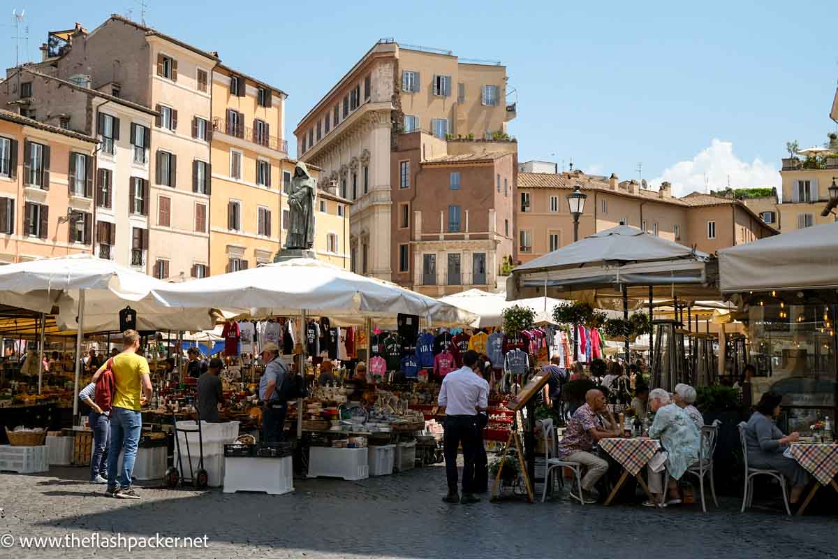 market square in rome italy with people sitting at cafes