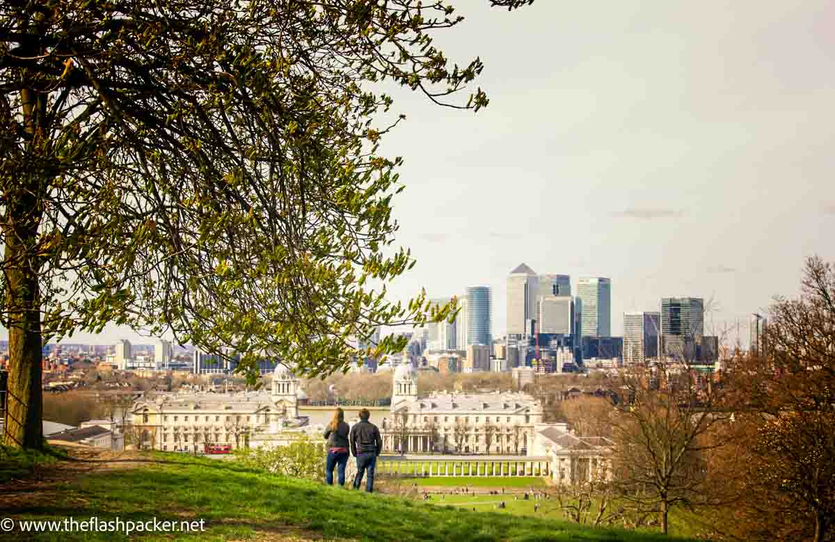 two people looking at canary-wharf-london-from-greenwich-park