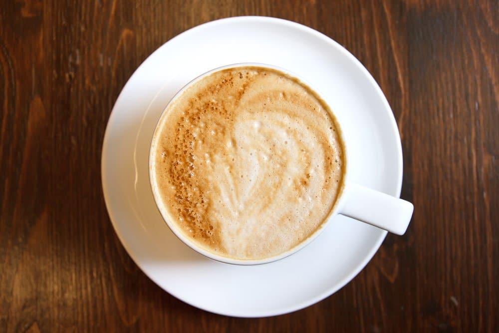 classic cup of cappucino coffee with milky foam