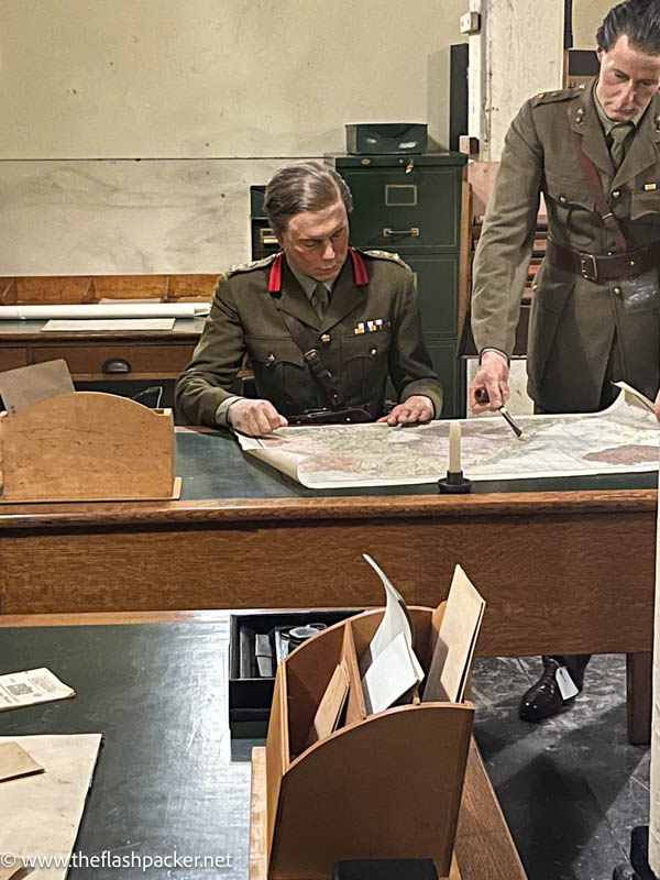 models of 2 solders looking at a map in a war office