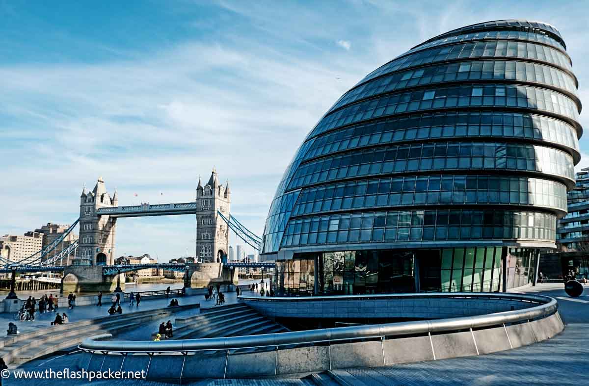 spiral bulbous modern building of London's city hall next to tower bridge