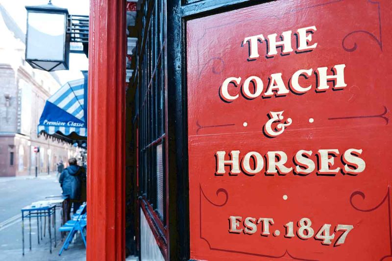 red sign for coach and horses pub