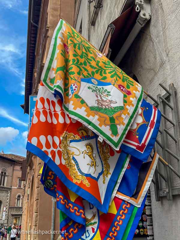 brightly coloured flags hanging from a wall