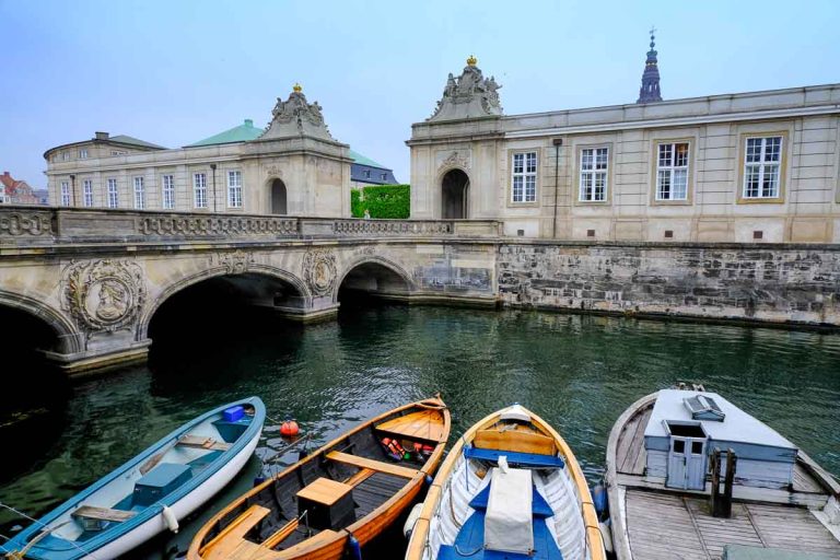 stationary boats on canal next to stone bridge seen in one day in copenhagen