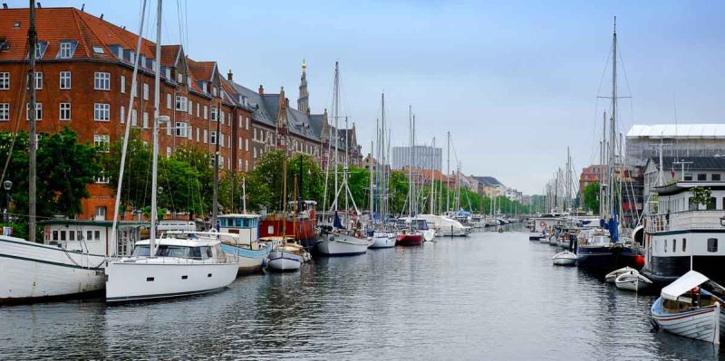 a canal in copenhagen lined with moored boats