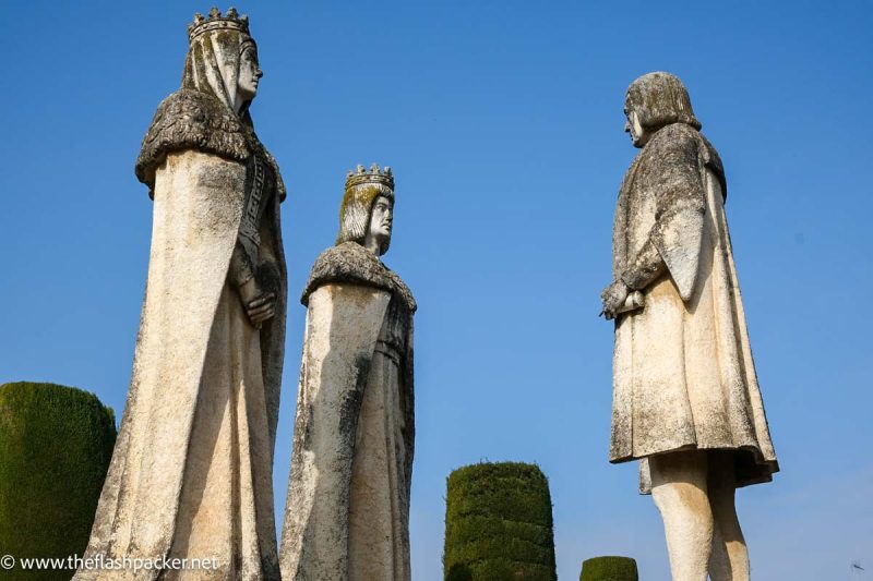 stone statue of christopher colombus and isabelle and ferdinand