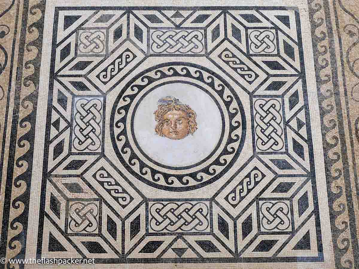 roman mosaic of mythological creature and geometric shapes