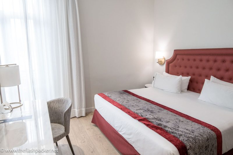 hotel room in eurostars azahar cordoba with large bed dressed in red and white