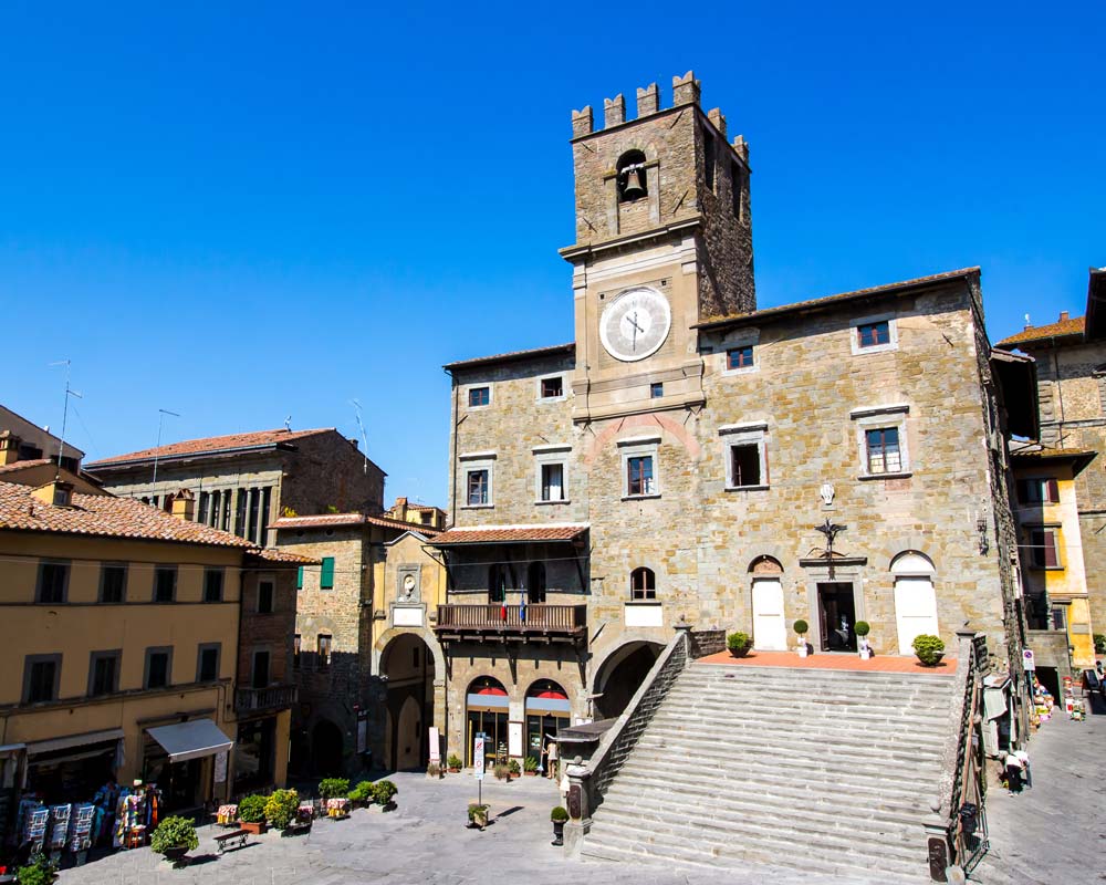 old buildings with clock tower in cortona in tuscany italy