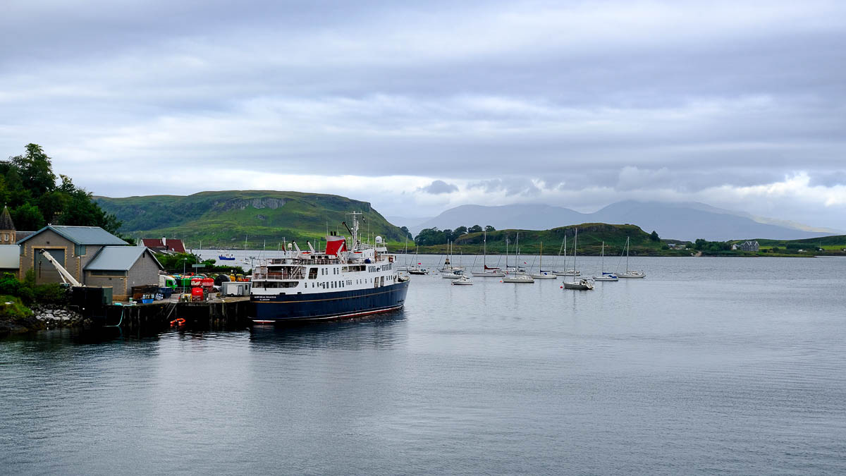 a small car ferry and small boats in a harbour