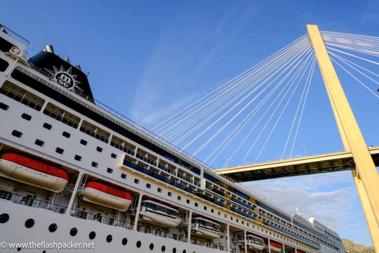 exterior of cruise ship showing cabin windows and lifeboats