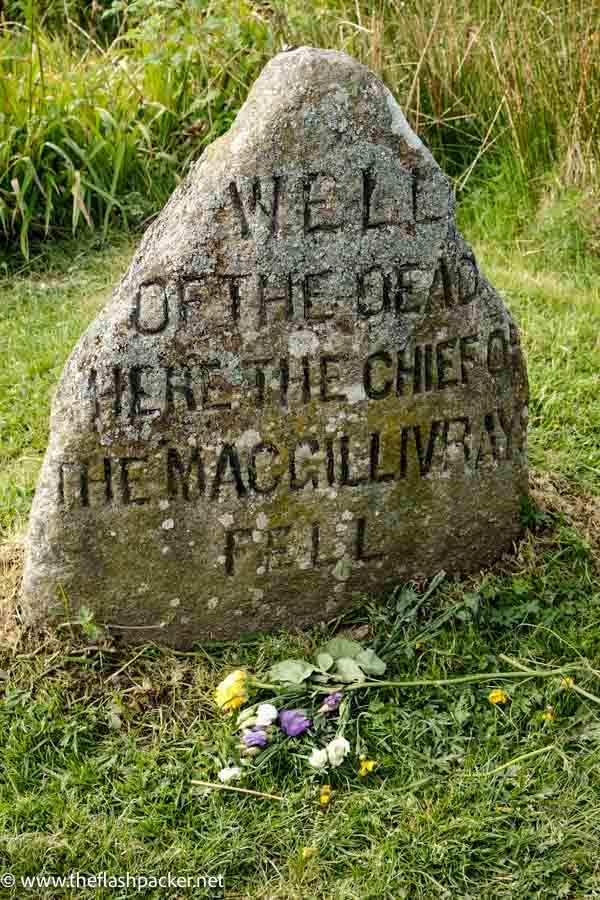 simple tombstone in grassy filed at culloden scotland