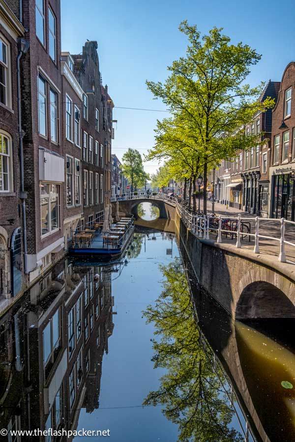 canal with small stone bridge seen during one day in delft