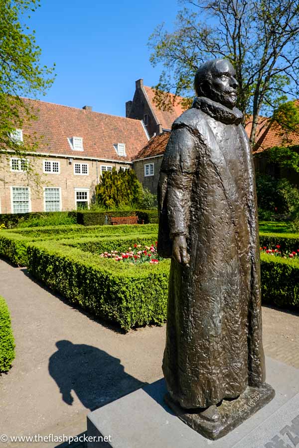 bronze statue in front of prisenhof museum one of the best things to see in delft netherlands