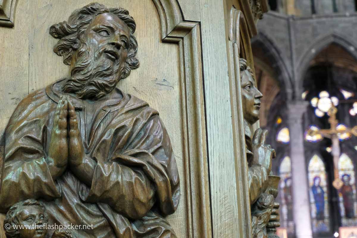 carved figures on side of pulpit in notre dame church in dinant belgium