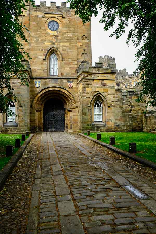 pathway leading to gateway of durham castle with a turret