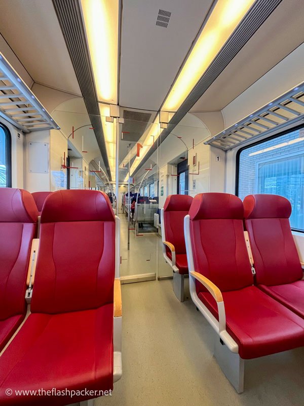 empty train carriage with red seats