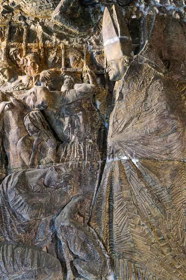 bronze bas relief sculpture of bishop and people