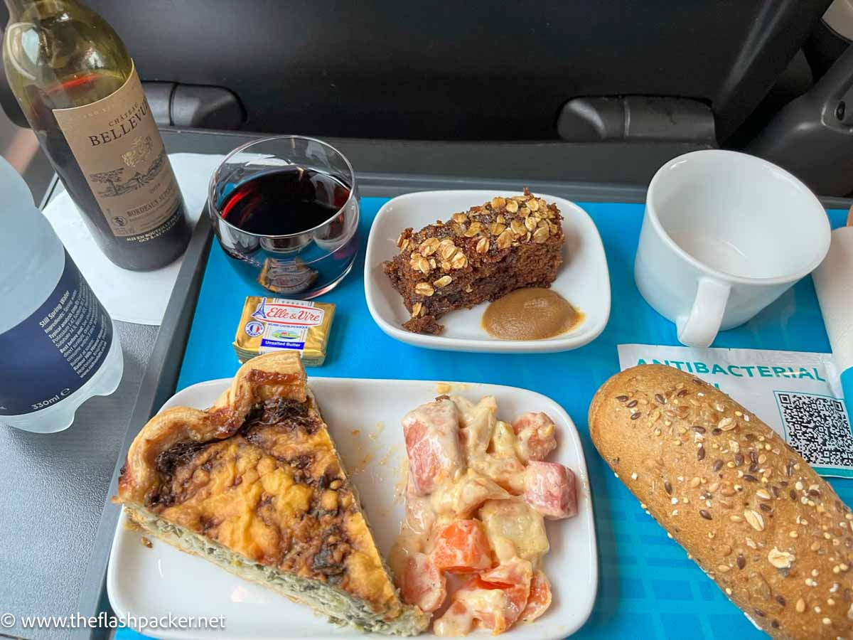 eurostar standard premier meal on a tray consisting of a quiche and salad, date slice and bread roll with wine and water