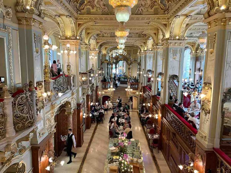 people dining in the ornate interior of new york cafe budapest