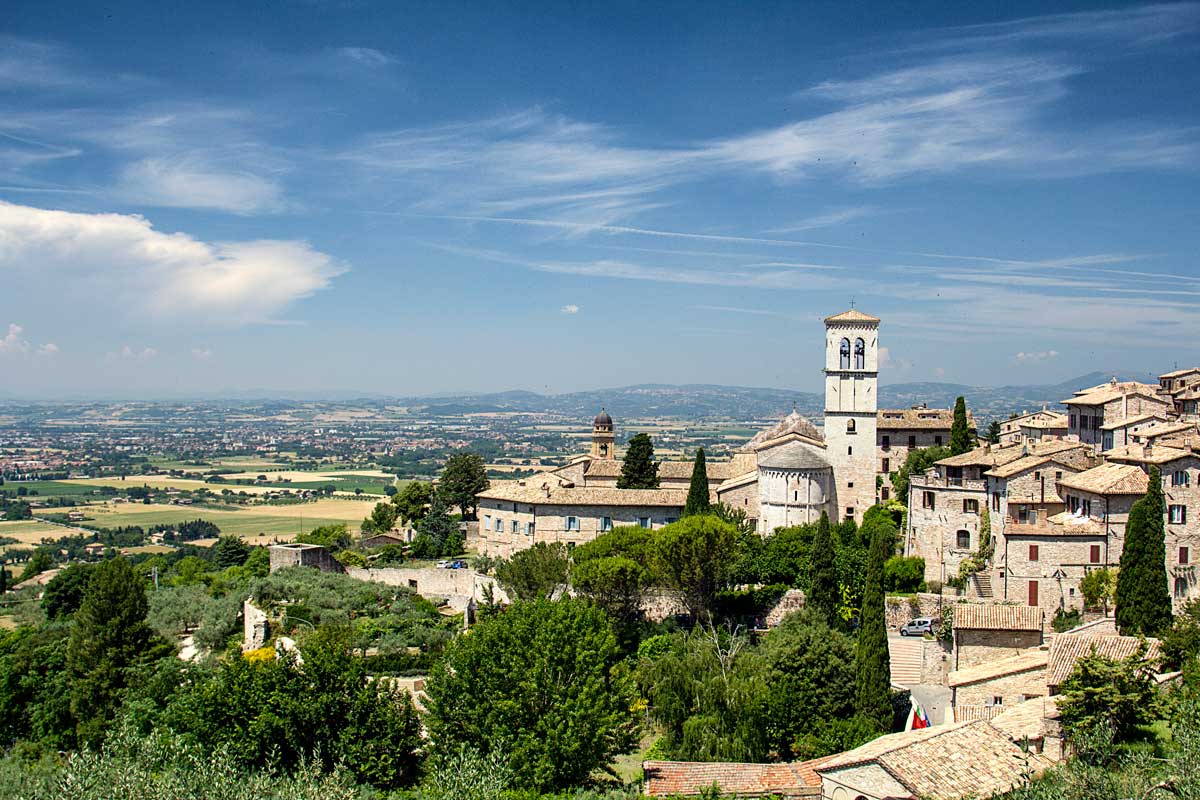 medieval town set amongst rolling countryside in italy